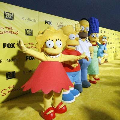 Characters (from L-R) Lisa, Bart, Homer, Marge and Maggie stand by a cake at the 20th anniversary party for the television series 'The Simpsons' in Santa Monica, California October 18, 2009. [CCTV via Agencies]