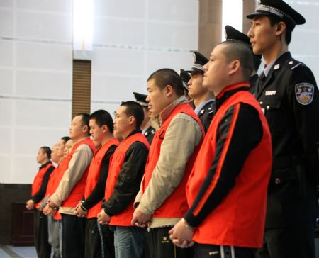 Yang Tianqing(front, R1) and other members of a criminal gang are seen during the trial at No. 1 Intermediate People's Court, in southwest China's Chongqing Municipality, Oct. 21, 2009. Six people convicted in connection with organized crime gangs were sentenced to death at two courts here on Wednesday.[Xinhua] 