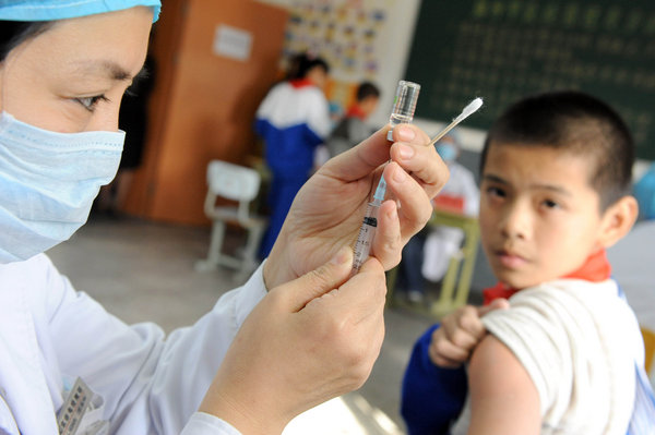 A student receives an H1N1 vaccine injection at a middle school in Beijing October 21, 2009. Beijing started Wednesday inoculating students, medical staff, public servants and elderly people with A/H1N1 flu vaccine free of charge, a local disease control and prevention official said. [CFP]