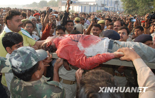 People carry an injured at the train collision site near the Mathura railway station, some 80 kilometers from New Delhi, capital of India, October, 21, 2009.[Xinhua]