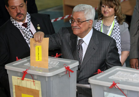 File photo taken on Aug. 9, 2009 shows Palestinian President Mahmoud Abbas casting his vote during the Fatah congress in the West Bank town of Bethlehem. Abbas on Friday called on the Palestinians in the Palestinian territories to hold the general legislative and presidential elections on Jan. 24, 2010. [Xinhua] 