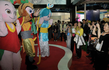 Visitors take pictures of models in cartoon costumes during a cartoon creative industry fair held in Wuhu, east China's Anhui Province, Oct. 23, 2009. The 2nd China International Cartoon Creative Industry Fair kicked off at Wuhu International Exhibition Center on Friday, attracting 238 enterprises and organizations from home and abroad. [Xinhua]