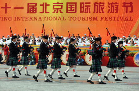 Performers from Britain play bagpipes during a parade at the Olympic Park in Beijing, capital of China, on Oct. 23, 2009. The 11th Beijing International Tourism Festival opening here on Friday brought together about 3000 performers from 71 countries and regions, as well as 18 disctricts and counties of Beijing. [Luo Xiaoguang/Xinhua] 