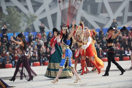 International performers dance during a parade at the Olympic Park in Beijing, capital of China, on Oct. 23, 2009. [Xinhua]