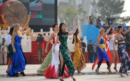  Performers dance during a parade at the Olympic Park in Beijing, capital of China, on Oct. 23, 2009. [Xinhua]