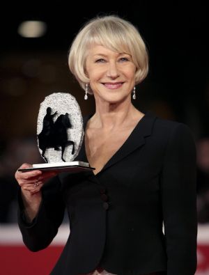 Actress Helen Mirren poses with her award on the red carpet at the Rome Film Festival October 23, 2009. Mirren received the Silver Marc