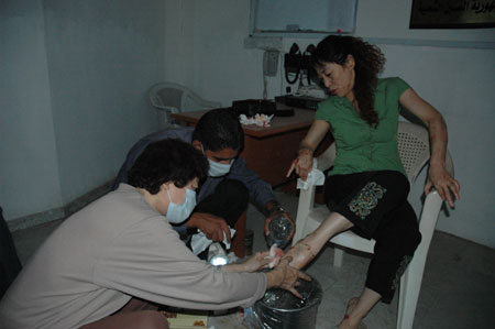 Staff members of the Chinese embassy in Iraq help treating a Chinese cook injured in a car bomb near the building of Baghdad provincial council in Baghdad, capital of Iraq, Oct. 25, 2009. At least 132 people were killed and 512 others injured in two car bomb explosions which rocked central Baghdad on Sunday. (Xinhua/Gao Shan)