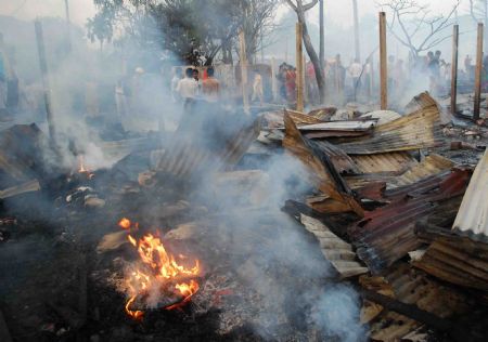 A fire destroyed a slum area in the eastern Indian city of Siliguri, October 25, 2009. More than one thousand people evacuated after a fire swept through the slum area and the cause of the fire is still unknown, a fire official said on Sunday.