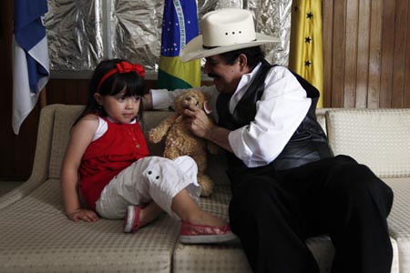 Honduras' ousted President Manuel Zelaya plays with his granddaughter Irene Melara at the Brazilian embassy in Tegucigalpa October 25, 2009. Talks between ousted Honduran President Zelaya and the country's de facto leaders collapsed this week, throwing efforts to resolve a political crisis sparked by a June 28 coup back to square one.