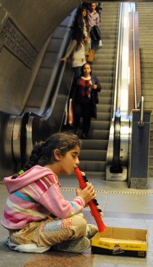 Helin Aslan, an eight-year-old girl, begs for money at the Levent Metro Station in Istanbul, the largest city of Turkey, Oct. 25, 2009. She is one of thousands of children who are pushed onto the streets every passing year to earn money through begging. Organized crime groups pick suitable spots for child beggars, including close to restaurants, shops, hospitals, bus stations, local bazaars, subways and ATMs. Experts define child begging as a form of exploitation and even abuse. The state is urged to take an immediate action to prevent children from being forced into begging.(Xinhua/Chen Ming)