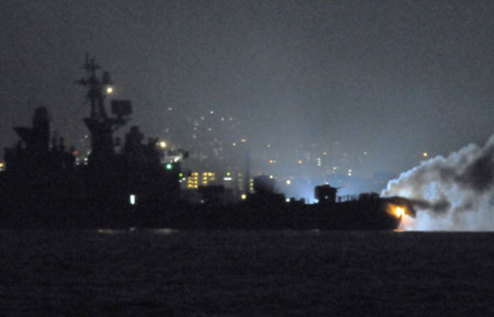Fire and smoke spew from the bow of Japanese Maritime Self-Defense Force (JMSDF) destroyer Kurama as a ship tries to fight the fire in the Kammon Straits in Fukuoka prefecture, south of Japan October 27, 2009. (Xinhua/AFP Photo)
