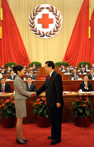Hu Jintao (R front), Chinese president and honorary president of the Red Cross Society of China (RCSC), shakes hands with Pan Meier, a Chinese laureate of the 42nd Florence Nightingale Award, who is a head nurse of a skin disease hospital in east China's Zhejiang Province, during the opening ceremony of the 9th national conference of the RCSC in Beijing, capital of China, Oct. 27, 2009. (Xinhua/Ma Zhancheng)