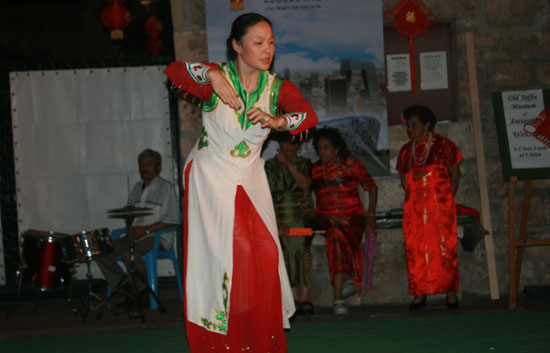 A lady dances at the opening ceremony of the photo exhibition 'A Close Look at China,' held at the Museum of Antiquities in Jaffa, Israel, October 19, 2009.