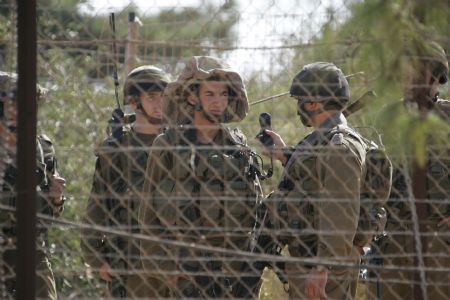 Israeli soldiers patrol the border with Lebanon near Kfarkila village in south Lebanon October 28, 2009. Lebanese army soldiers found and deactivated four rockets on Wednesday in the area from where a rocket had been fired towards northern Israel, witnesses said.