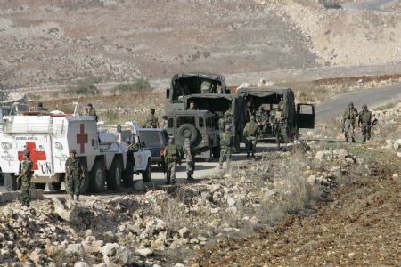 Lebanese soldiers and U.N peacekeepers patrol a road in Houla village in south Lebanon October 28,2009. Lebanese army soldiers found and deactivated four rockets on Wednesday in the area from where a rocket had been fired towards northern Israel, witnesses said.