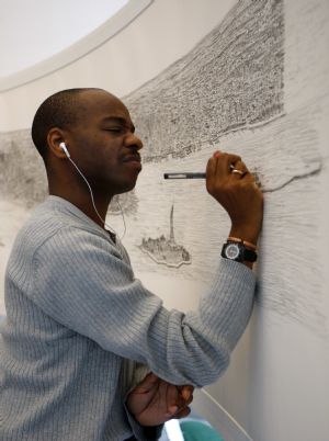 British artist Stephen Wiltshire works on a hand-drawn panorama of the skyline of New York, from a studio at the Pratt Institute in Brooklyn October 28, 2009.(Xinhua/Reuters Photo)