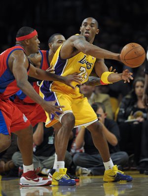 Kobe Bryant (R) of Los Angeles Lakers passes the ball during the match between Lakers and Clippers at Staples Center, Los Angeles, Oct. 27, 2009. Lakers won 99-92. (Xinhua/Qi Heng)