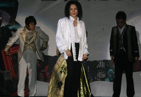 Michael Jackson impersonator Zhao Dan (front, middle) leads the dance 'Ghosts' at the premiere ceremony of 'Michael Jackson's This Is It' at Solana Square in Beijing, October 27, 2009. 