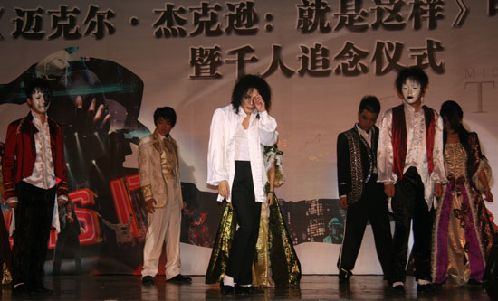 Michael Jackson impersonator Zhao Dan (front, middle) leads the dance 'Ghosts' at the premiere ceremony of 'Michael Jackson's This Is It' at Solana Square in Beijing, October 27, 2009.