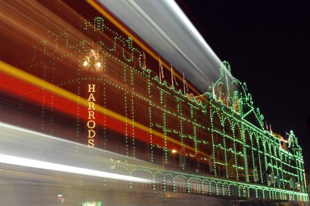 A bus passes the Harrods retail store in London October 29, 2009. The world-famous department store's 11 500 white light bulbs have been changed to green bulbs for this year's Christmas lights display.(Xinhua/Reuters Photo)