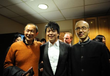 Famous composer Tan Dun (L), Chen Qigang (R) and pianist Lang Lang have a photo taken on the backstage after Lang Lang