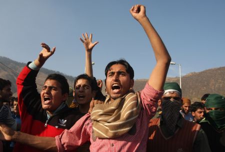 Kashmiri Muslim protesters shout slogans during a protest rally in Baramulla, about 55 kilometers (34 miles) north of Srinagar, summer capital of Indian controlled Kashmir, Oct. 30, 2009. Thousands of Kashmiris protested against Indian rule in the disputed Kashmir on a call by a key political hardline leader and demanded demilitarization of the region on Friday. Key hardline leader Syed Ali Geelani led the protest march and rejected Indian Prime Minister Manmohan Singh's latest offer for talks saying there can be no two-way dialogue unless New-Delhi declares Kashmir disputed and withdraws its troops from the scenic region and meets other condition. (Xinhua/Javed Dar) 
