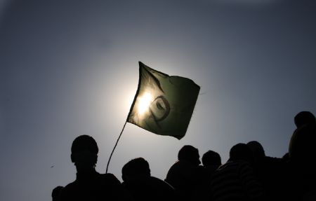 Kashmiri Muslim protesters hold a flag during a protest rally in Baramulla, about 55 kilometers (34 miles) north of Srinagar, summer capital of Indian controlled Kashmir, Oct. 30, 2009. (Xinhua/Javed Dar)