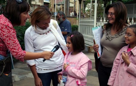 A Greek Cypriot reporter interviews a Turkish Cypriot student during her vist in Nicosia, capital of Cyprus, Nov. 1, 2009.(Xinhua/Wang Qiang)