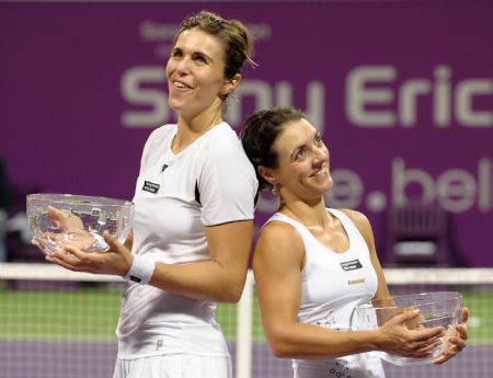 Maria Jose Martinez Sanchez (L) and compatriot Nuria Llagostera Vives of Spain pose with their champion trophies after defeating Cara Black of Zimbabwe and Liezel Huber of the U.S. during the final match of women's doubles at the WTA Tour Championships in Doha, Qatar, Nov. 1, 2009. (Xinhua/Chen Shaojin)