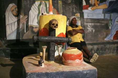 A Haitian woman attends a voodoo ceremony in a temple during Day of the Dead celebrations in Belladere November 2, 2009.