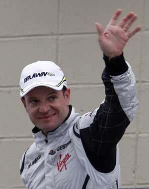 Brawn GP Formula One driver Rubens Barrichello of Brazil waves to the crowd after finishing the qualifying session with the best time to take the pole position at the Interlagos racetrack in Sao Paulo October 17, 2009. 