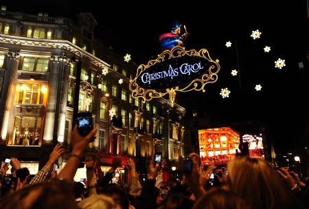 People gather at the intersection of the Oxford Street, the Regent Street celebrating for Christmas lights switched on in London, capital of Britain, on Nov. 3, 2009. The annual Christmas Lights Switch-on ceremonies were held on the Oxford Street, the Regent Street and the City of London on Tuesday evening, marking the launch of this year's Christmas shopping season. (Xinhua/Zeng Yi)