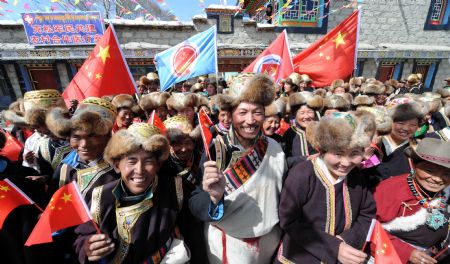 Local villagers celebrate to mark the 50th anniversary of the emancipation of millions of serfs and slaves in old Tibet at Kesum village of Nedong County, southwest China's Tibet Autonomous Region, March 23, 2009. (Xinhua/Gesang Dawa)