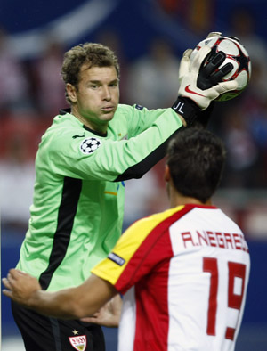 Jens Lehmann (L), goalkeeper of VfB Stuttgart, catches the ball next to Alvaro Negredo of Sevilla during their Champions League soccer match in Seville Nov. 4, 2009.(Xinhua/Reuters Photo) 