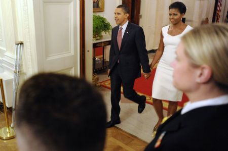 U.S. President Barack Obama and his wife Michelle arrive to play host to an evening of classical music in the East Room of the White House in Washington November 4, 2009. 