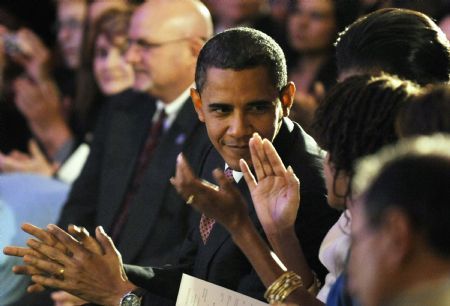 U.S. President Barack Obama (C) and his family applaud during an evening of classical music in the East Room of the White House in Washington, November 4, 2009.