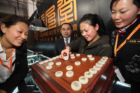 A staff worker shows jade Chinese chess on a jewelry exhibition held at China International Exhibition Center in Beijing, China, Nov. 5, 2009. The 5-day-long 2009 China International Jewelry Exhibition kicked off here on Thursday with about 600 companies from 15 countries and regions on shown. (Xinhua)