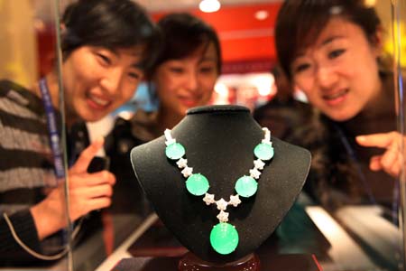 Visitors view a jade necklace on a jewelry exhibition held at China International Exhibition Center in Beijing, China, Nov. 5, 2009. The 5-day-long 2009 China International Jewelry Exhibition kicked off here on Thursday with about 600 companies from 15 countries and regions on shown. (Xinhua)