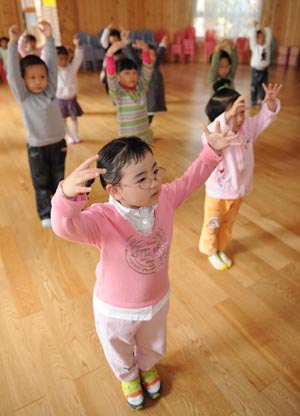 Song Xinyi, an earthquake orphan, gestures during a dancing class in her kindergarten in Chengdu, capital city of southwest China's Sichuan Province, on Oct. 26, 2009. 