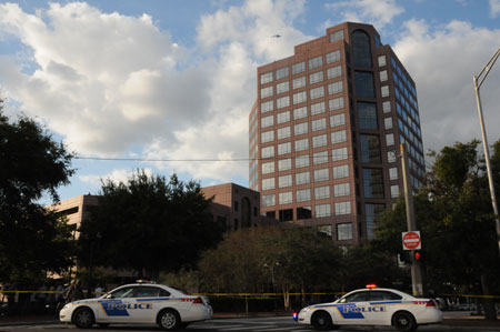 Two police cars park outside the Gateway Center building where a shooting incident took place in downtown Orlando, Florida, the U.S., Nov. 6, 2009. A gunman on Friday opened fire inside the Gateway Center building, killing at least one person and wounding at least five others. (Xinhua/Zhou Xiaozheng)