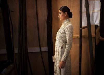 A model wearing a creation by Pakistani designer Aeisha Varsey is photographed backstage before taking the catwalk during Pakistan Fashion Week in Karachi on November 4, 2009. The four day long event, which was rescheduled twice due to security concerns, features over 30 Pakistani designers, organizers said.(Xinhua/Reuters Photo)