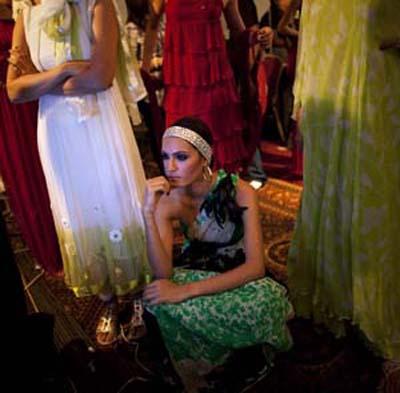 Model Nadia Hussain, wearing a creation by Pakistani designer Samar Mehdi, sits amidst others backstage while awaiting to take the catwalk during Pakistan Fashion Week in Karachi on November 4, 2009.(Xinhua/Reuters Photo)