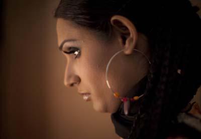 A model wearing a creation by Pakistani designer Shamaeel is photographed backstage moments before taking the catwalk during Pakistan Fashion Week in Karachi on November 4, 2009.(Xinhua/Reuters Photo)