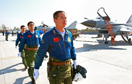 The picture taken on October 31 shows Yan Feng (front), commander of an aviation division, which the “August First” Aerobatics Team belongs to, is leading the pilots of J-10 demonstration fighters to walk to the planes for training.