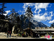 Soaring to 5500m, some 35km from Lijiang, is Yulong Xueshan, also known as Mt Satseto. In Lijiang City you can have a magnificent view of Jade Dragon Snow Mountain, with the main peak thrust into the clouds, the Old Man Peak standing out on the right and Black Snow Peak on its left. The 13 peaks of 18,360-foot Jade Dragon Snow Mountain, a treasure of wild plants and rare animals, are like a silver dragon lying in the clouds. Awesome and unconquered, they dominate the Lijiang Plain. [Photo by Sarah] 