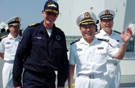 Wang Zhiguo (R front), the commander of the Chinese naval 3rd escort fleet, speaks with Pieter Bindt, commander of the European Union (EU) navy 465 formation during the latter's visit to the Chinese 'Zhoushan' Warship at Wang's invitation at the Gulf of Aden Nov. 8, 2009.[Guo Gang/Xinhua] 