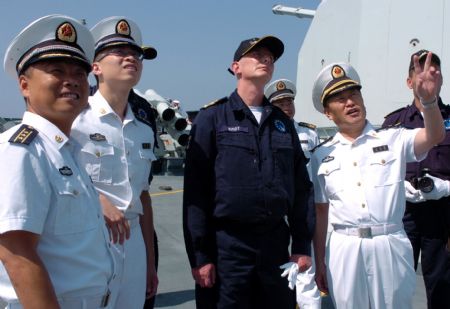 Wang Zhiguo (1st R, front), commander of the Chinese naval 3rd escort fleet, points as Pieter Bindt (2nd R, front), commander of the European Union (EU) navy 465 formation, looks on during Pieter Bindt's visit to [Guo Gang/Xinhua]the Chinese 'Zhoushan' Warship at Wang's invitation at the Gulf of Aden Nov. 8, 2009.[Guo Gang/Xinhua]