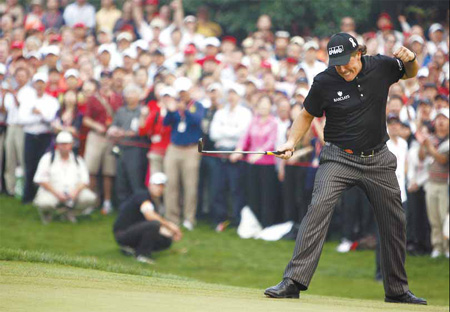 Phil Mickelson of the US reacts after sinking a crucial putt at the 17th hole at the HSBC Champions tournament in Shanghai yesterday.[China Daily]