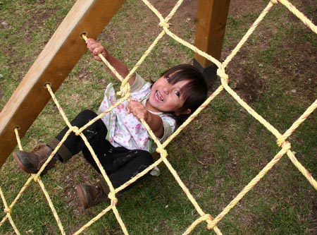 A kid plays at the kindergarten of a women's prison in Quito, Ecuador, Nov. 6, 2009. [Hao Yunfu/Xinhua]