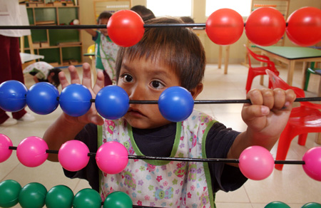 A kid plays at the kindergarten of a women's prison in Quito, Ecuador, Nov. 6, 2009. [Hao Yunfu/Xinhua]